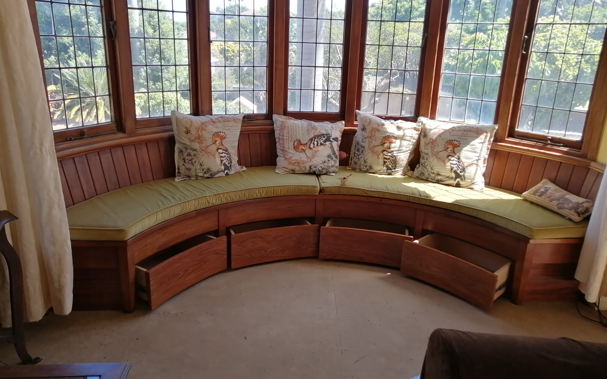 View this project in the gallery Finished curved solid wood window seating with integrated storage
